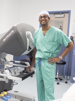 Pavan Atluri in an operating room with the daVinci robot